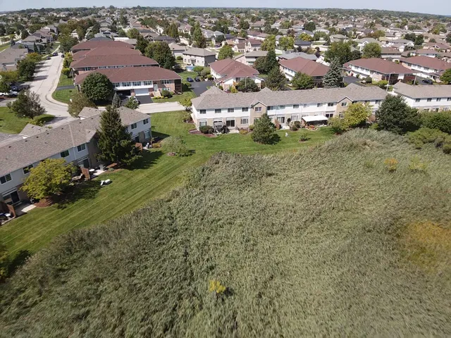 an aerial view of residential houses with outdoor space
