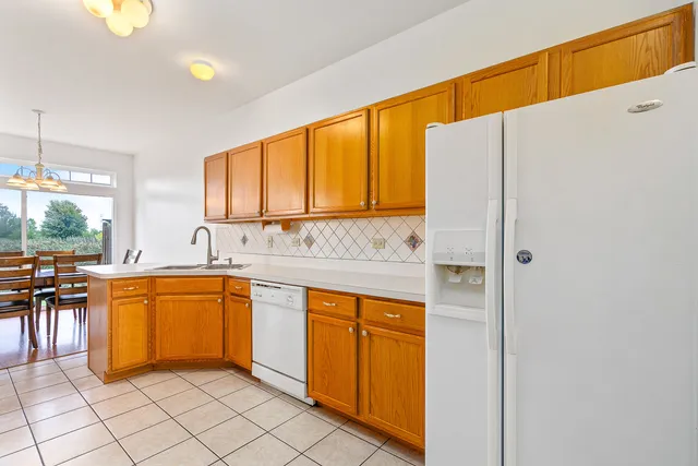 a kitchen with stainless steel appliances granite countertop a sink and cabinets