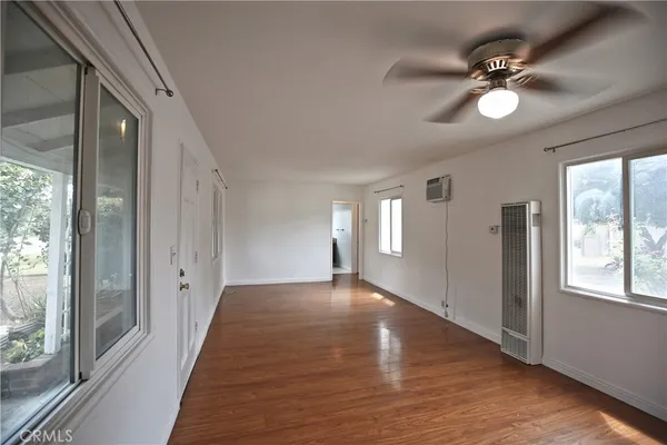 a view of a livingroom with a ceiling fan and window
