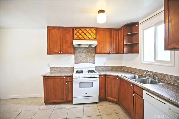 a kitchen with a stove sink and cabinets