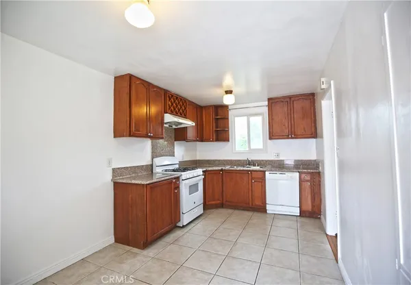 a kitchen with stainless steel appliances granite countertop a sink and stove top oven