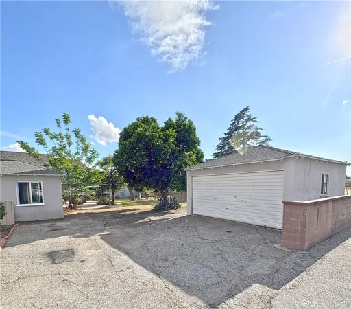 a view of a house with a yard and garage