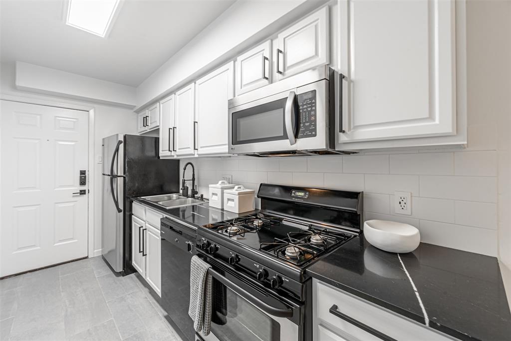 Welcome to 210 Emerson St Unit #2. Look at this stunning renovated kitchen with quartz countertops.