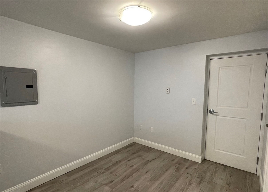 233 Lafayette Street, Unit 25 Salem, MA 01970 - Photo 7 of 9 an empty room with wooden floor and windows