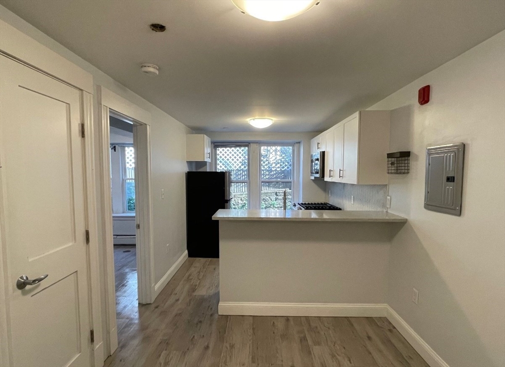 233 Lafayette Street, Unit 25 Salem, MA 01970 - Photo 8 of 9 a view of kitchen with wooden floor