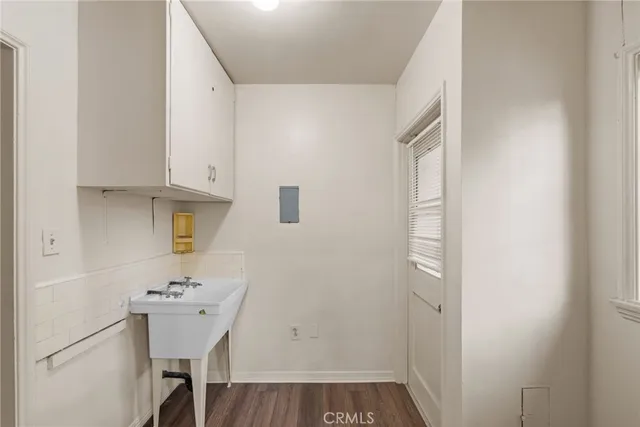 a view of a room with wooden floor and cabinets