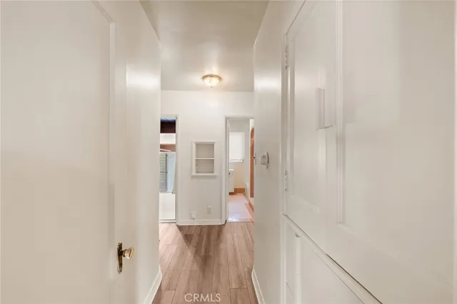 a view of a hallway with wooden floor