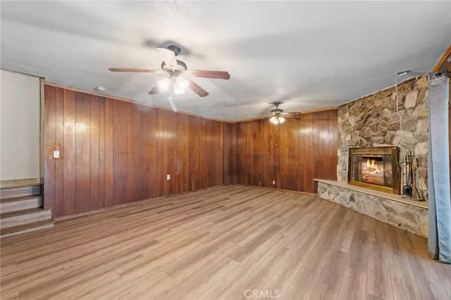 a view of an empty room with a fireplace and a window
