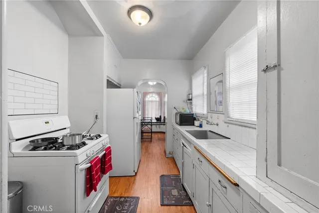 a hallway with sitting area and chandelier