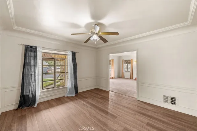 wooden floor in an empty room with a window
