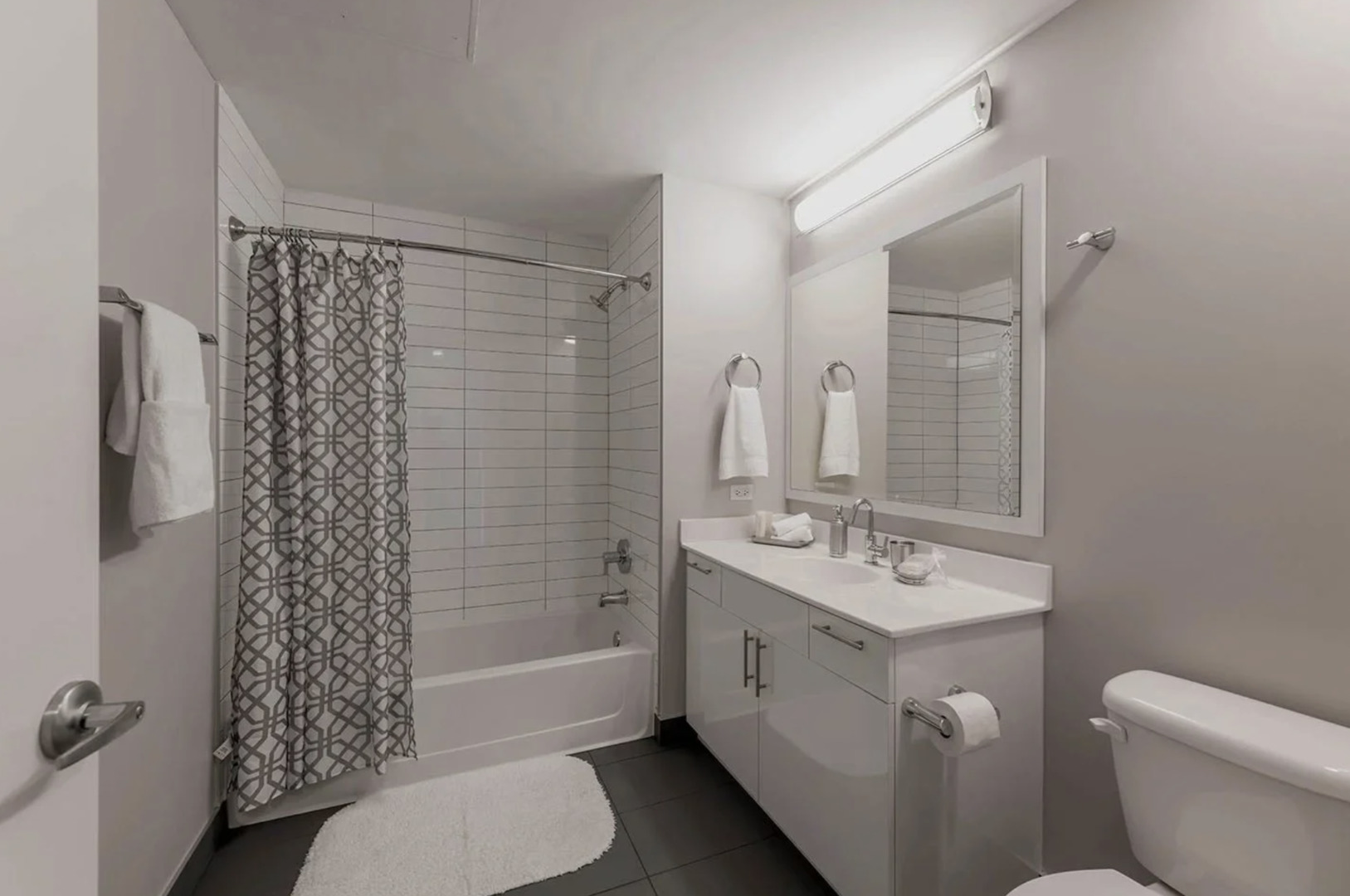 211 West Scott Street, Unit 408 Chicago, IL 60610 - Photo 6 of 8 a bathroom with a sink toilet and shower