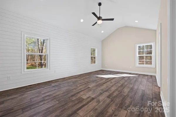 a view of an empty room and wooden floor
