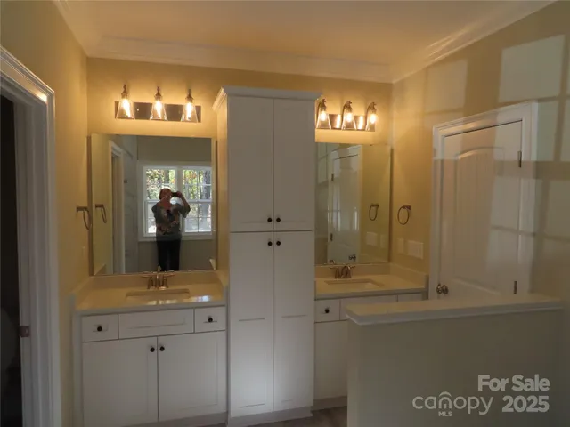 a large kitchen with kitchen island a sink table and chairs