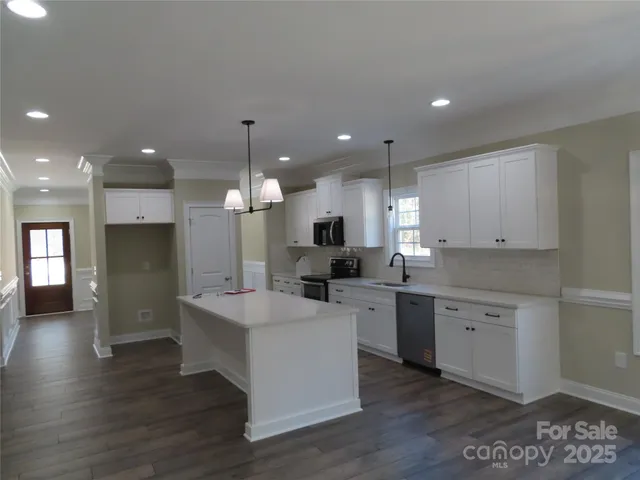 an entryway with wooden floor and livingroom view