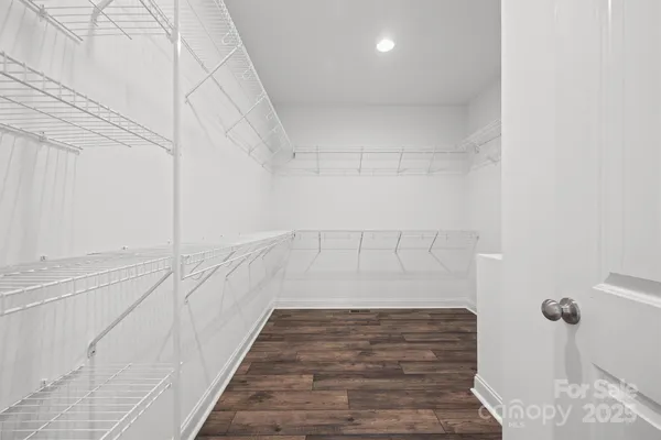 a spacious bathroom with a double vanity sink a mirror and a shower