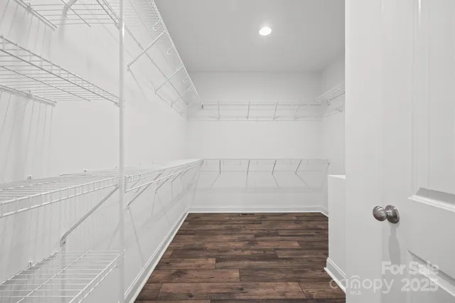 a spacious bathroom with a double vanity sink a mirror and a shower