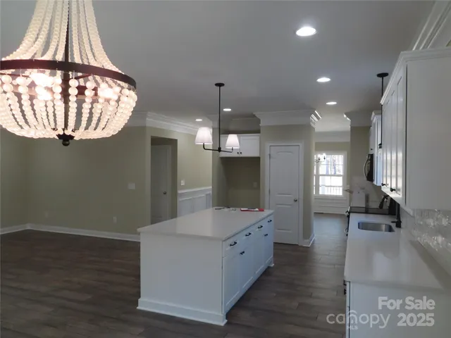 a kitchen with white cabinets and a sink