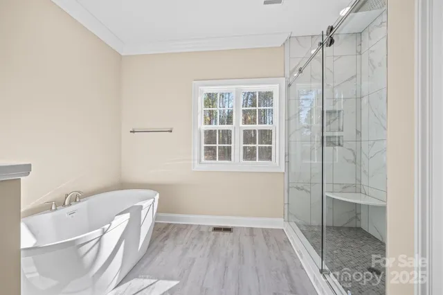 a spacious bathroom with a shower sink and mirror