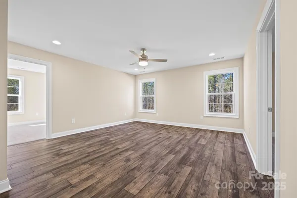 a view of an empty room and wooden floor