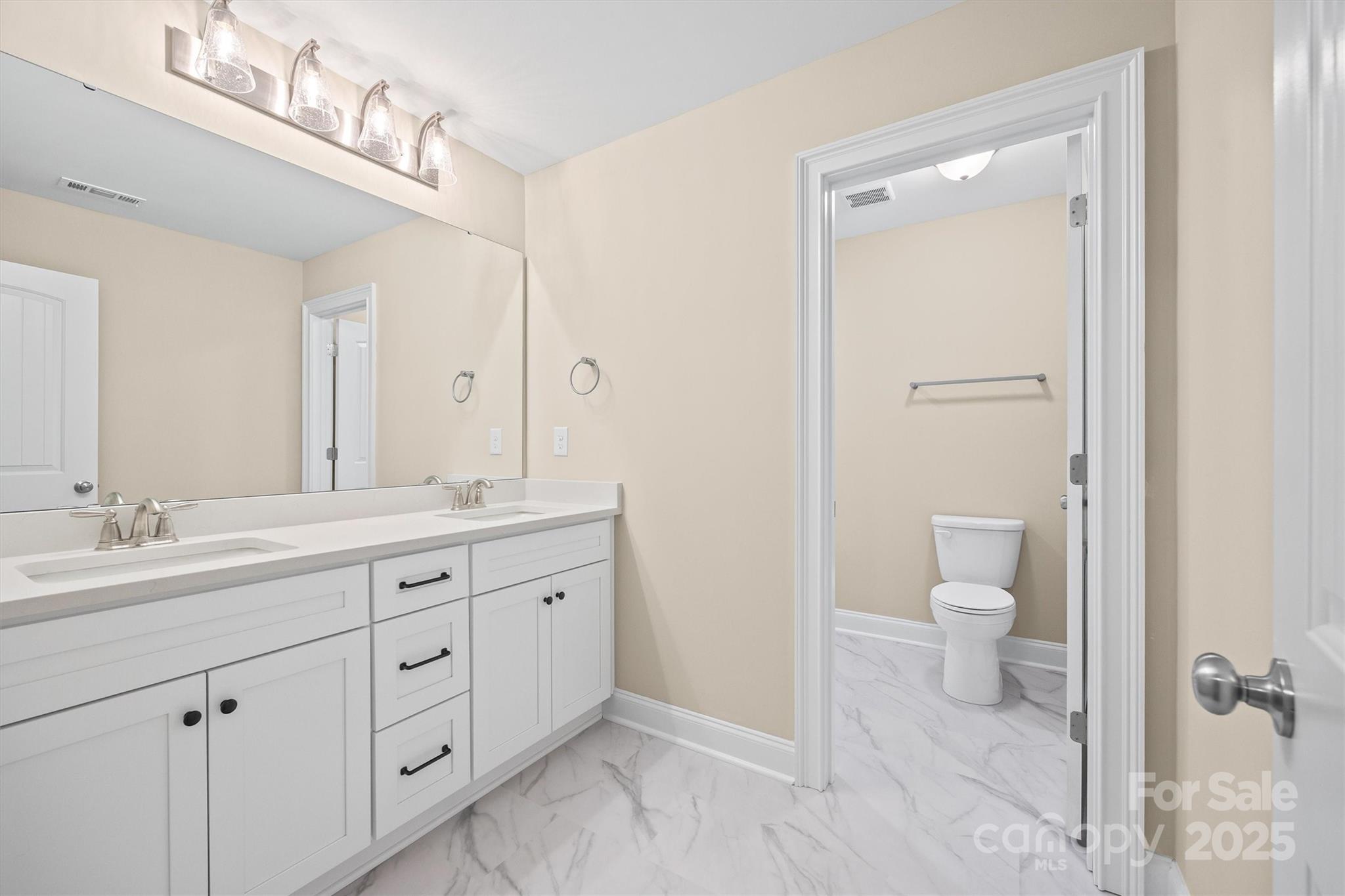 3812 Winter Road, Unit 5 Rock Hill, SC 29730 - Photo 35 of 37 a spacious bathroom with a double vanity sink a toilet and a mirror