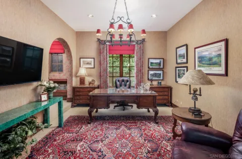 a living room with furniture a piano and a flat screen tv