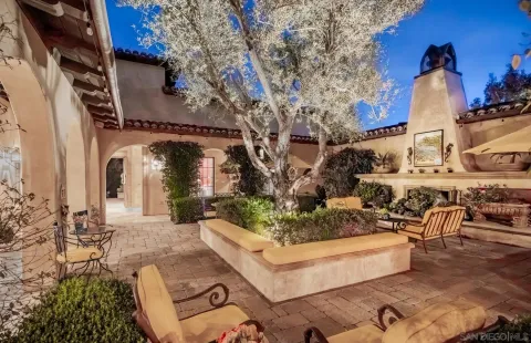 a view of a building with couches and a fire pit
