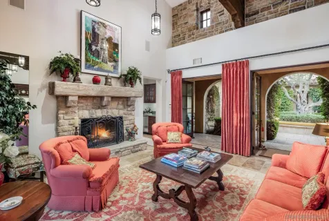 a living room with furniture fireplace and a large window