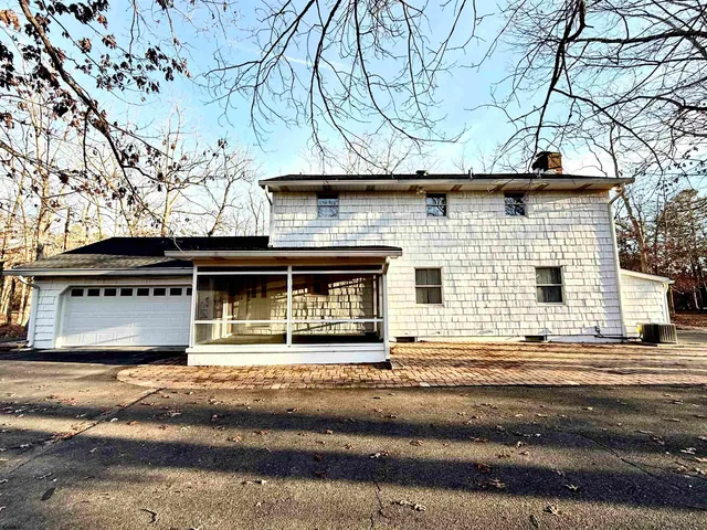 a house that has a tree in front of it