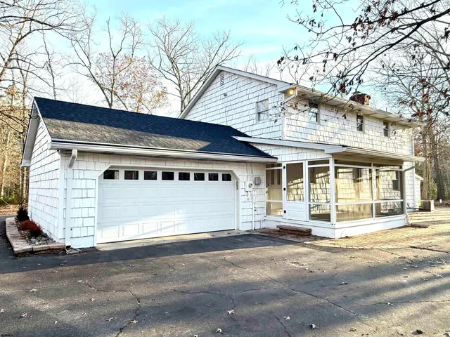 a front view of a house with a road