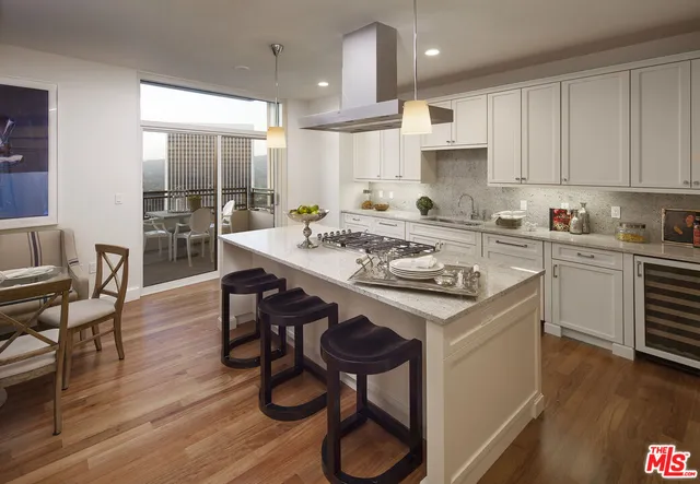 a kitchen with a table chairs stove and cabinets