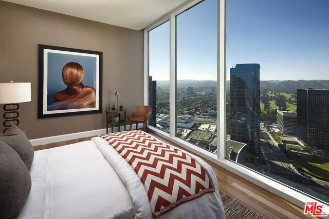a living room with furniture and a floor to ceiling window