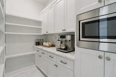 a view of a kitchen with a stove and a large window