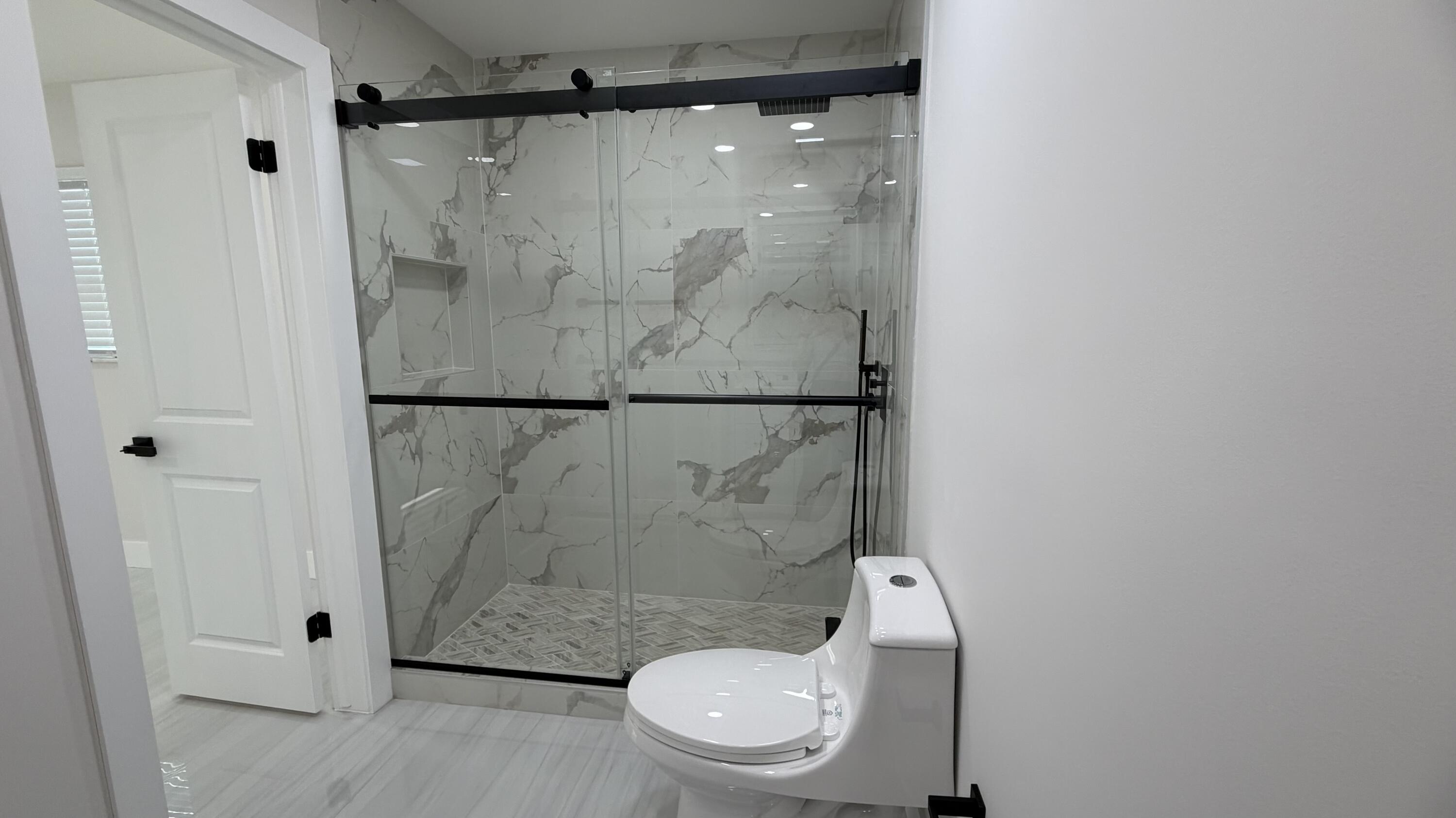 2521 Northeast 45th Street Lighthouse Point, FL 33064 - Photo 18 of 25 a white toilet sitting next to a shower