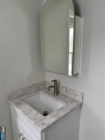 a close view of a sink and dishwasher in a bathroom