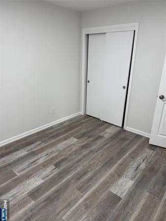 a view of room with wooden floor