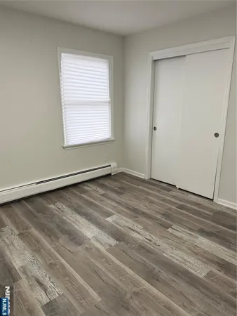 a view of a room with wooden floor and windows