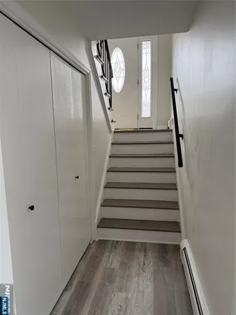 a view of entryway with stairs and wooden floor