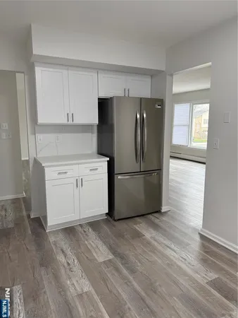 a kitchen with a refrigerator sink and cabinets