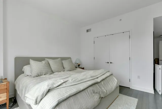 a bedroom with a bed and a mirror