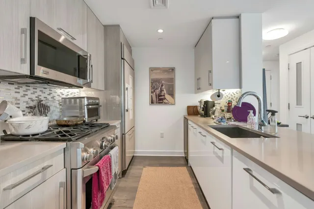 a kitchen with stainless steel appliances granite countertop a stove and a sink