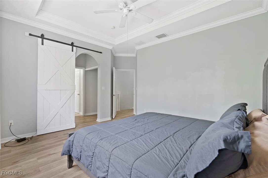 14617 Sutherland Avenue, Unit 80 Naples, FL 34119 - Photo 17 of 46 a bedroom with a bed and a ceiling fan