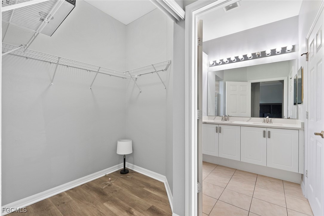 14617 Sutherland Avenue, Unit 80 Naples, FL 34119 - Photo 18 of 46 a view of a hallway with closet and chandelier fan