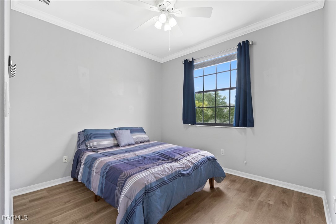 14617 Sutherland Avenue, Unit 80 Naples, FL 34119 - Photo 21 of 46 a bedroom with a bed and a window