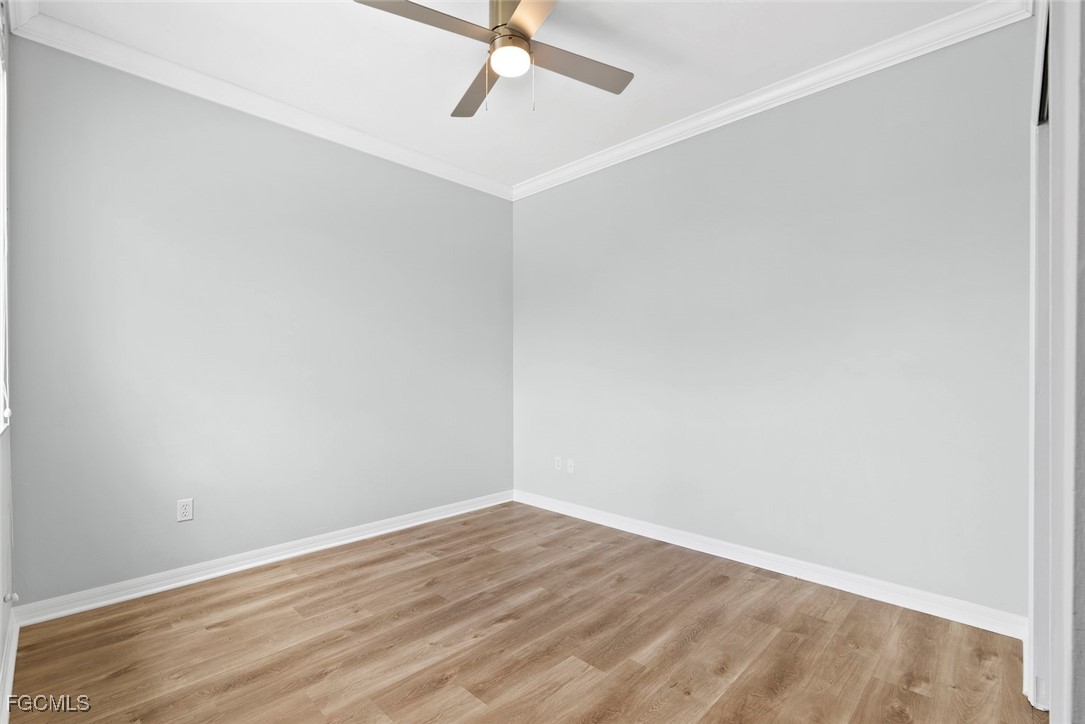 14617 Sutherland Avenue, Unit 80 Naples, FL 34119 - Photo 24 of 46 a view of an empty room with wooden floor
