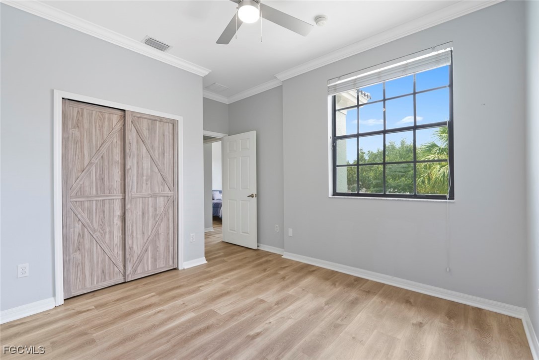 14617 Sutherland Avenue, Unit 80 Naples, FL 34119 - Photo 25 of 46 wooden floor in an empty room with a window
