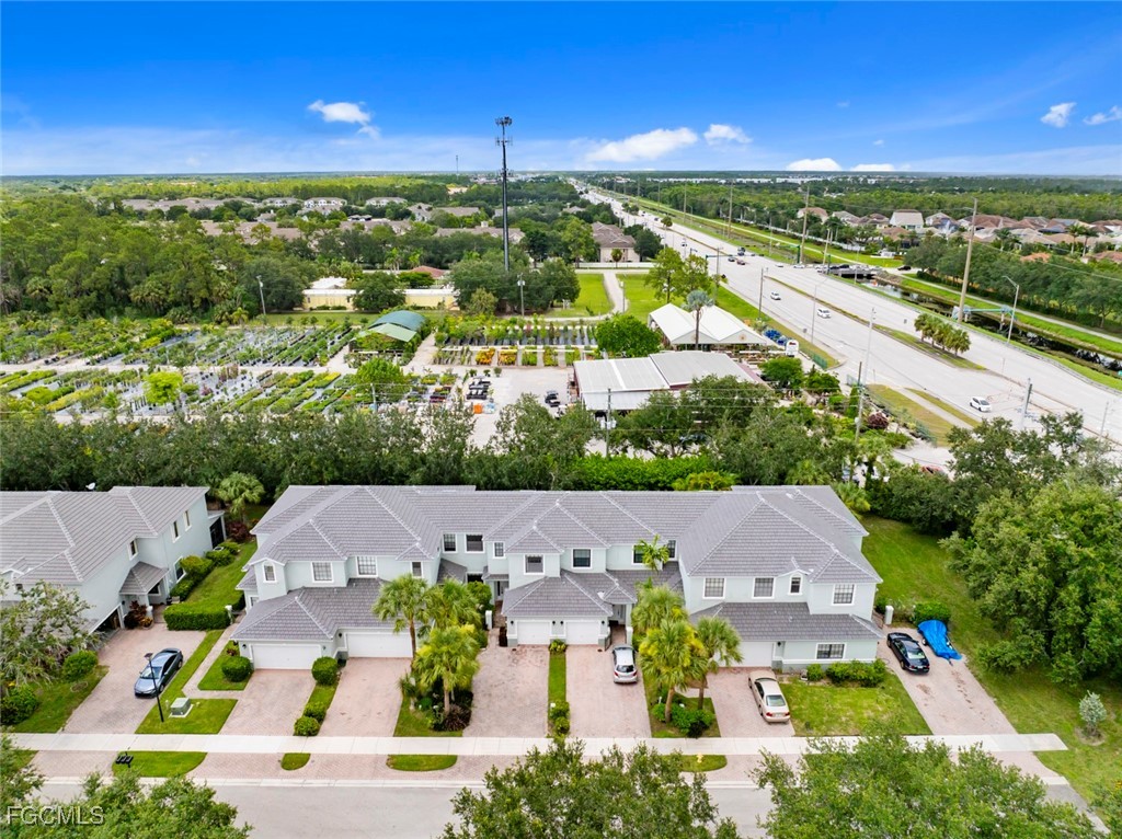 14617 Sutherland Avenue, Unit 80 Naples, FL 34119 - Photo 32 of 46 an aerial view of residential houses with outdoor space and street view