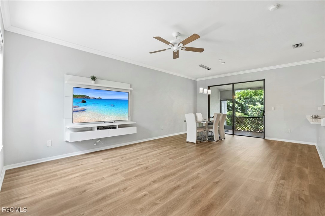 14617 Sutherland Avenue, Unit 80 Naples, FL 34119 - Photo 4 of 46 a view of livingroom with hardwood floor and window