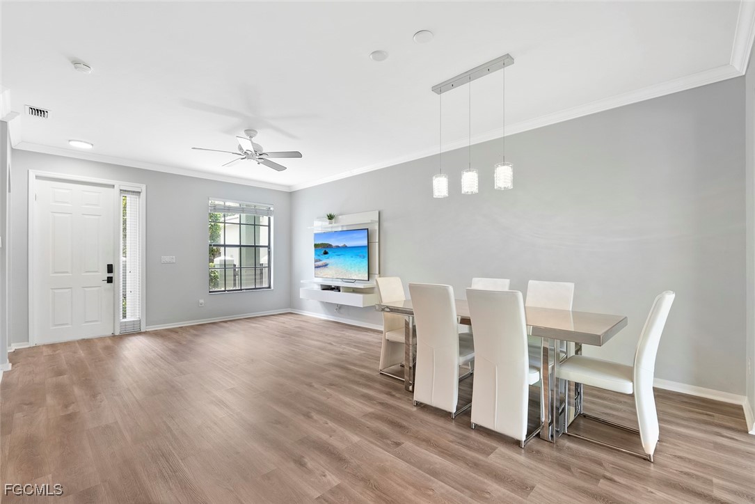 14617 Sutherland Avenue, Unit 80 Naples, FL 34119 - Photo 6 of 46 a view of a livingroom with a dinning table and chair