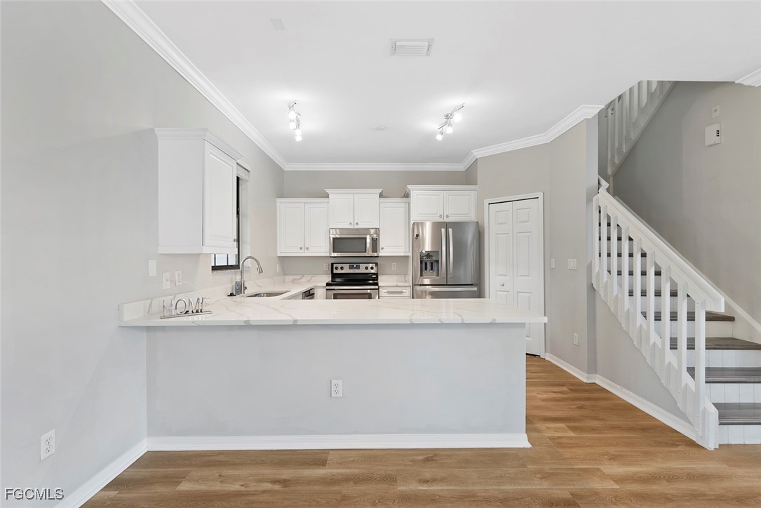 14617 Sutherland Avenue, Unit 80 Naples, FL 34119 - Photo 9 of 46 a view of kitchen with stainless steel appliances granite countertop refrigerator sink and stove