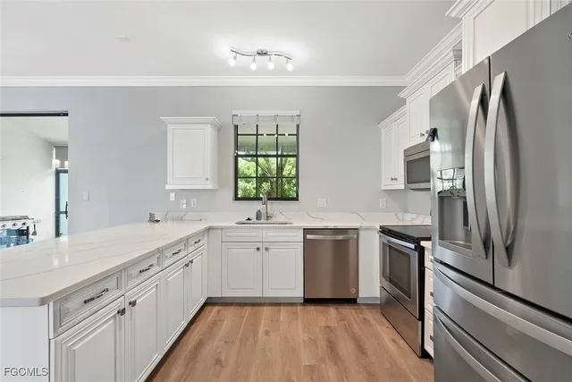 a kitchen with a refrigerator sink and stove